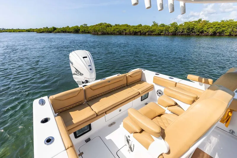 Slide: The Image of Manufacturer Provided Image: 2025 Sportsman Heritage 261 Center Console boat with tan seating on a calm waterway. - 18