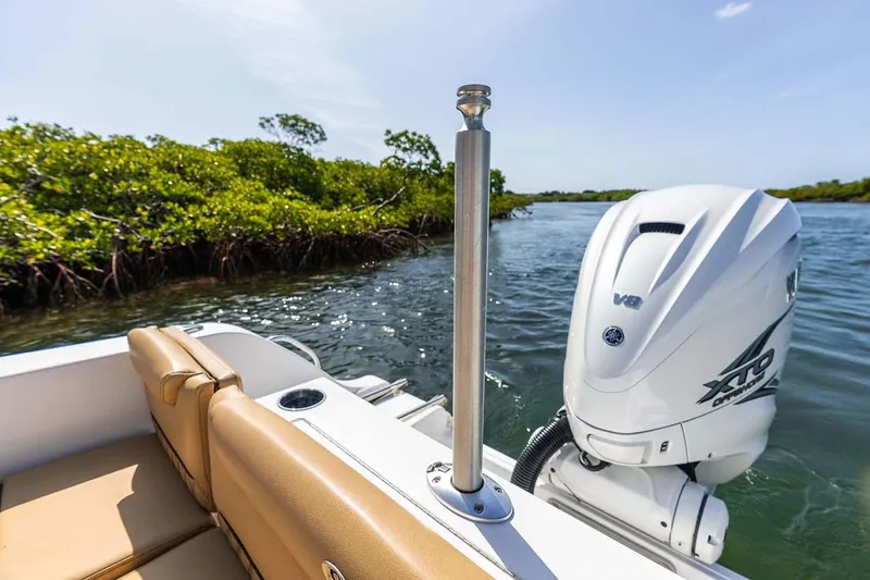 Slide: The Image of Manufacturer Provided Image: 2025 Sportsman Heritage 261 Center Console boat with powerful outboard motor on a sunny day. - 20