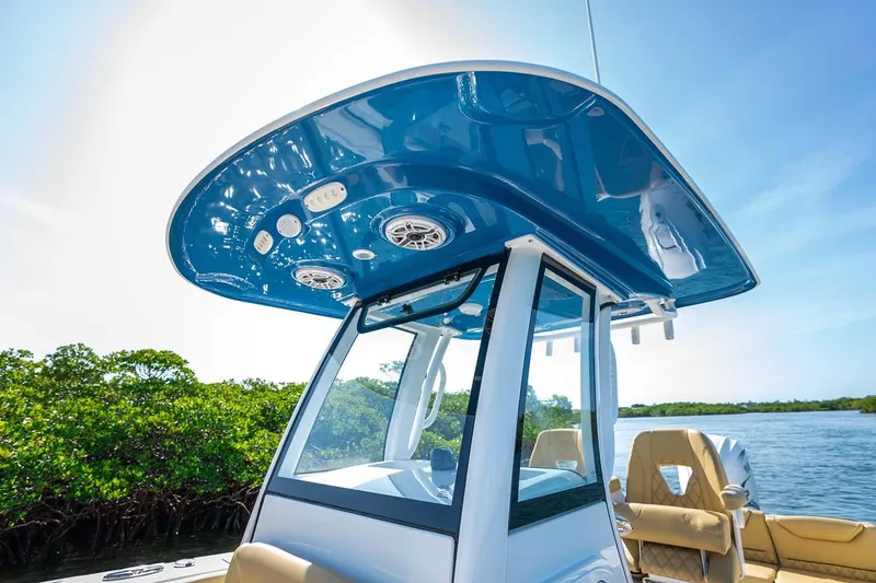 Slide: The Image of Manufacturer Provided Image: 2025 Sportsman Heritage 261 Center Console boat with blue T-top on a sunny day. - 12