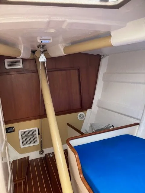 Slide: The Image of Interior of a 1979 Nautor Swan 441 with wooden walls and blue upholstery. - 18
