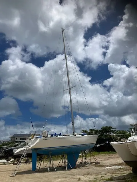 Slide: The Image of A 1979 Nautor Swan 441 is on a dry dock under a cloudy sky. - 20