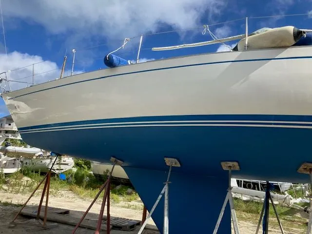 Slide: The Image of 1979 Nautor Swan 441 sailboat on stands, set against a clear sky. - 9