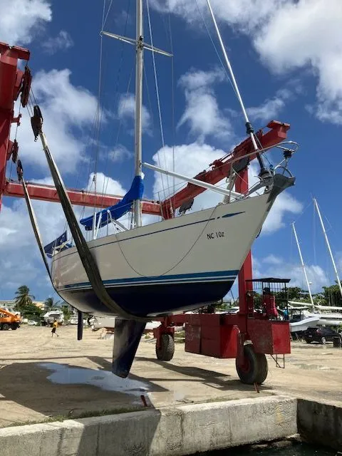 Slide: The Image of A 1979 Nautor Swan 441 being lifted out of the water by a crane. - 19