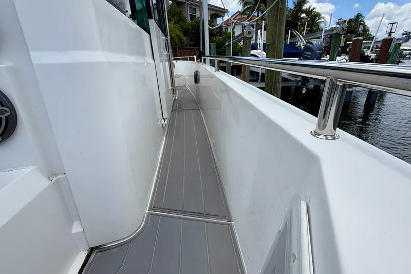 Slide: The Image of Side deck view of 2018 Axopar 37 Sports Cabin, featuring sleek design and railing. - 22