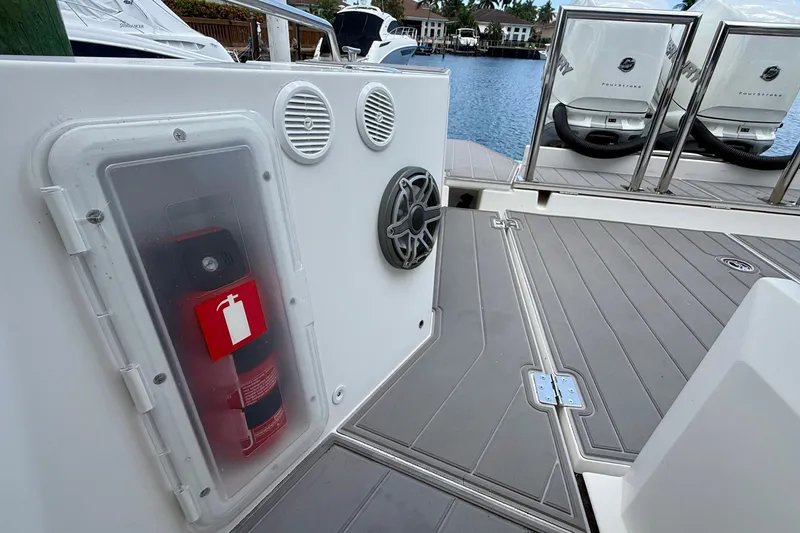 Slide: The Image of Fire extinguisher and speakers on 2018 Axopar 37 Sports Cabin boat deck. - 35