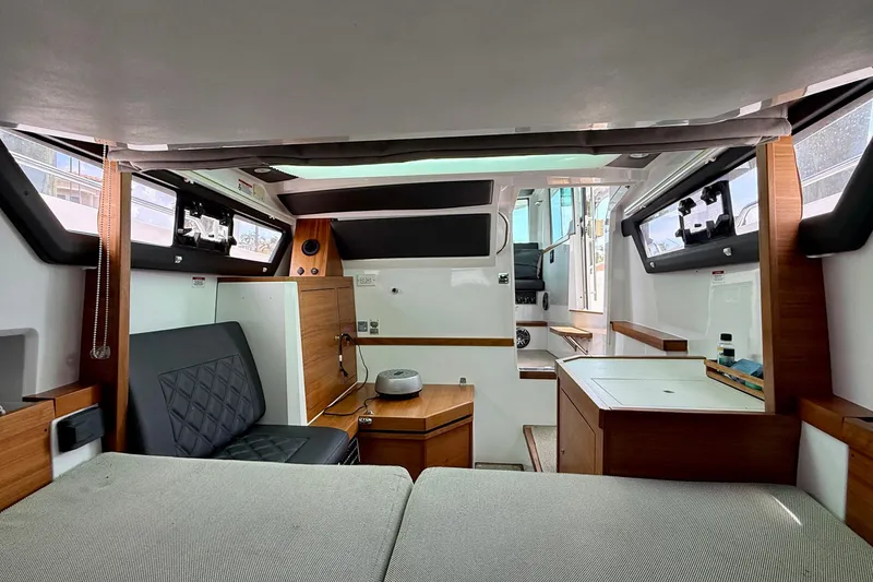 Slide: The Image of Interior of 2018 Axopar 37 Sports Cabin, featuring modern seating and wood accents. - 45