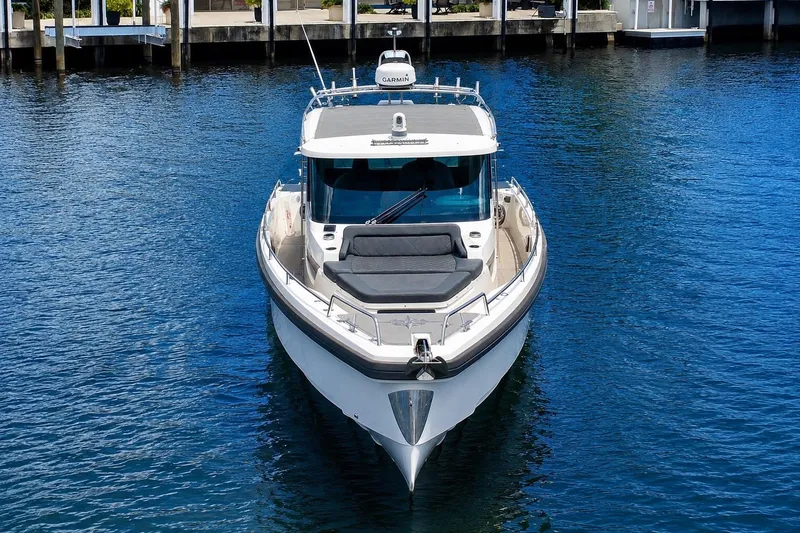 Slide: The Image of 2018 Axopar 37 Sports Cabin boat on calm water, front view. - 5