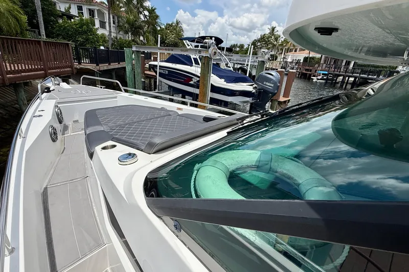 Slide: The Image of 2018 Axopar 37 Sports Cabin docked, featuring sleek design and spacious deck area. - 27