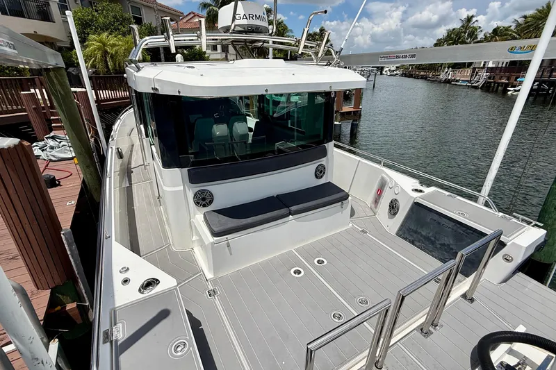 Slide: The Image of 2018 Axopar 37 Sports Cabin docked, featuring spacious deck and modern design. - 14