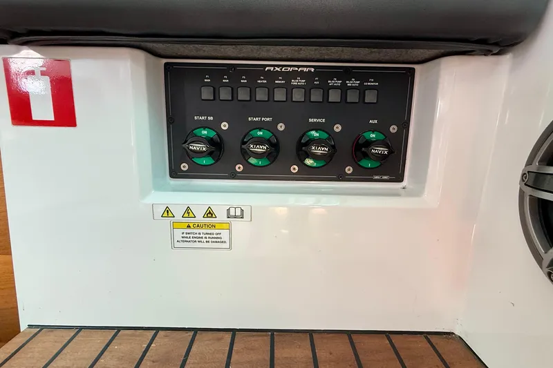 Slide: The Image of Control panel of a 2018 Axopar 37 Sports Cabin boat with caution label. - 39