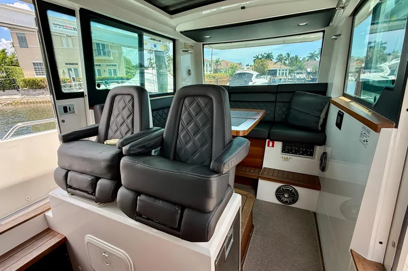 Slide: The Image of Interior of 2018 Axopar 37 Sports Cabin with leather seating and panoramic windows. - 42