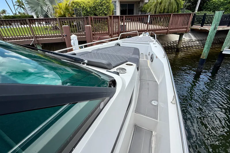 Slide: The Image of 2018 Axopar 37 Sports Cabin docked, showcasing sleek design and spacious deck. - 26