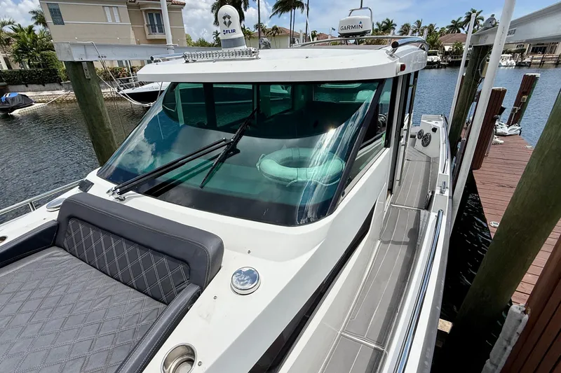 Slide: The Image of 2018 Axopar 37 Sports Cabin docked, featuring sleek design and modern amenities. - 28