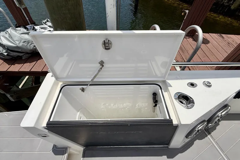 Slide: The Image of Open storage compartment on 2018 Axopar 37 Sports Cabin boat, dockside view. - 18
