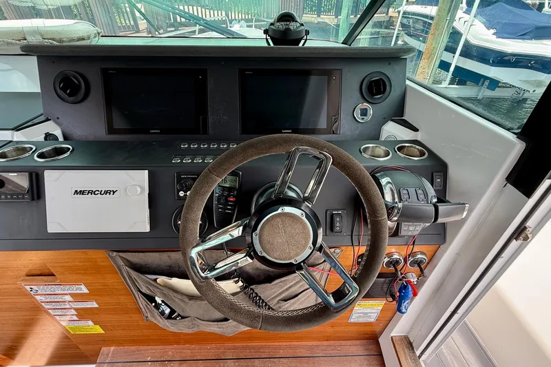 Slide: The Image of Helm of 2018 Axopar 37 Sports Cabin with Mercury controls and dual displays. - 37