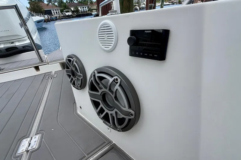 Slide: The Image of 2018 Axopar 37 Sports Cabin with marine speakers and audio system on deck. - 34