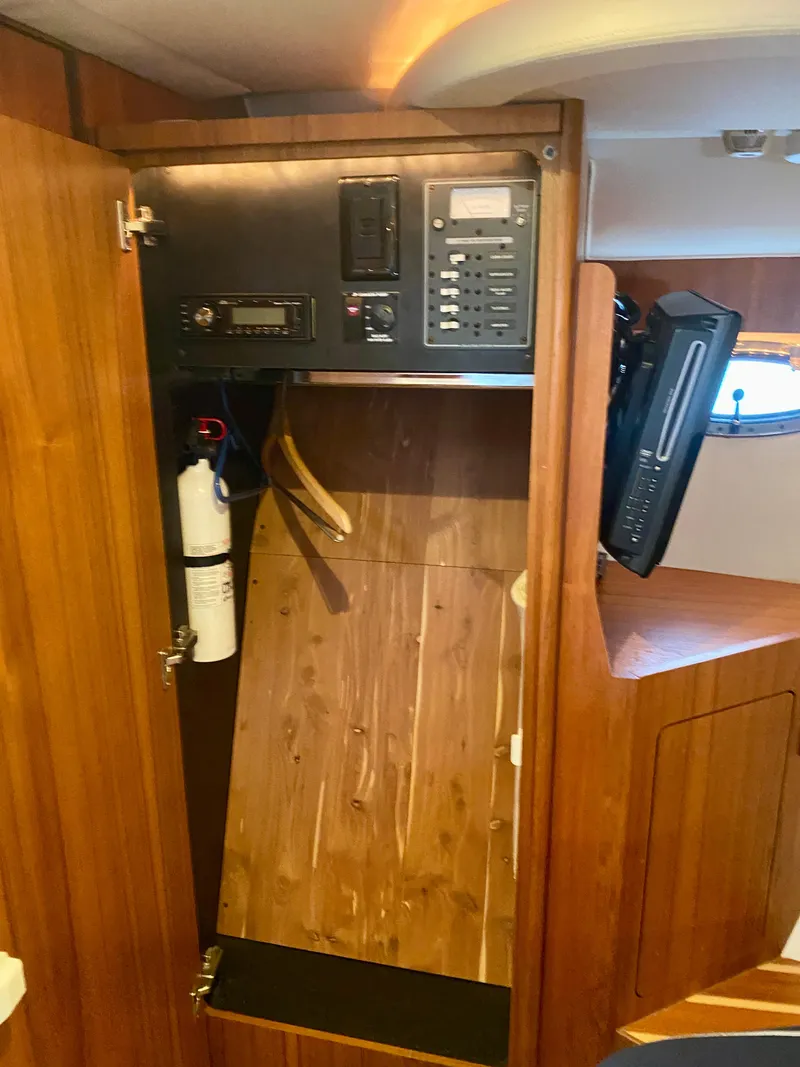 Slide: The Image of Interior view of a 2012 Tiara Yachts 3100 Coronet with wood paneling and an electronics panel. - 24