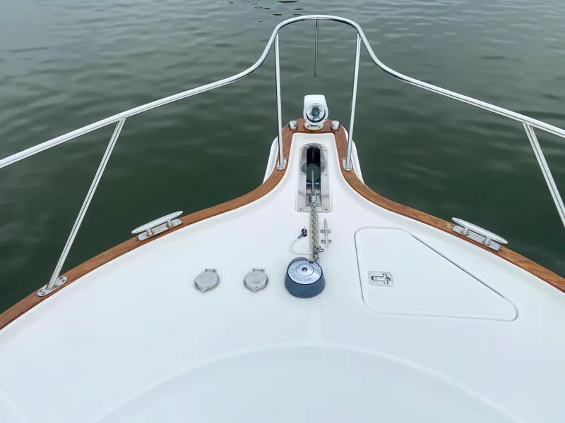 Slide: The Image of The bow of a 2012 Tiara Yachts 3100 Coronet with anchor windlass and wood accents. - 19