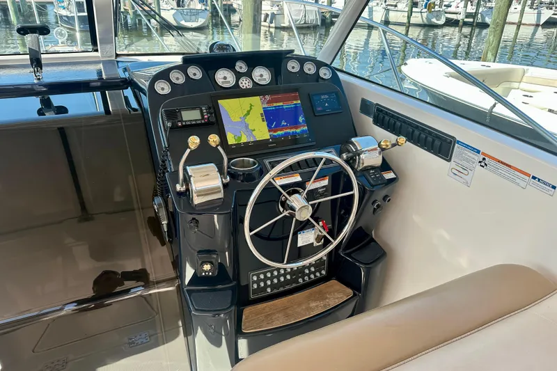 Slide: The Image of Cockpit of 2012 Tiara Yachts 3100 Coronet with navigation controls and display. - 11