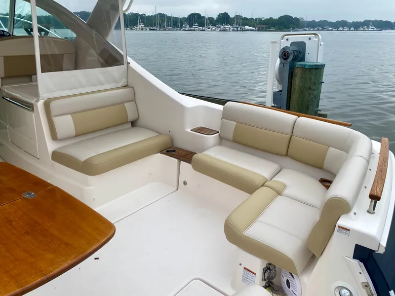 Slide: The Image of The image shows the cockpit of a 2012 Tiara Yachts 3100 Coronet with beige seating. - 9