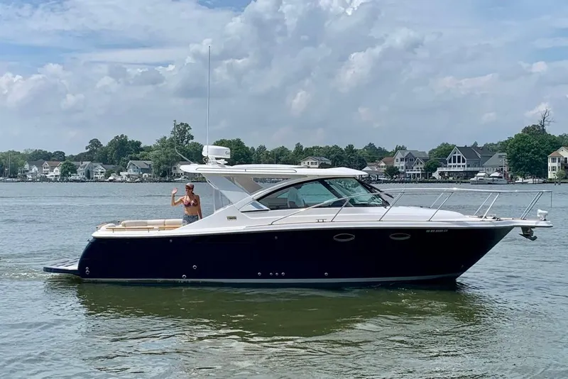 The Image of 2012 Tiara Yachts 3100 Coronet cruising on a scenic lake with houses in the background. - 0