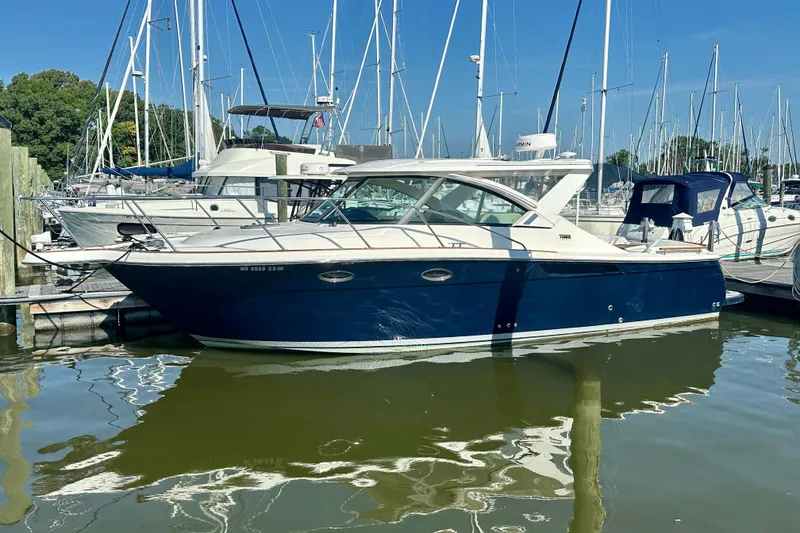 Slide: The Image of 2012 Tiara Yachts 3100 Coronet docked in a marina, surrounded by sailboats. - 5
