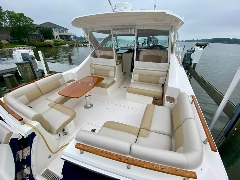 Slide: The Image of The image shows the cockpit of a 2012 Tiara Yachts 3100 Coronet with beige upholstery and a wooden table. - 7