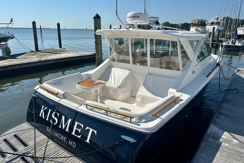 Slide: The Image of 2012 Tiara Yachts 3100 Coronet docked, featuring "Kismet" name, in Baltimore marina. - 1