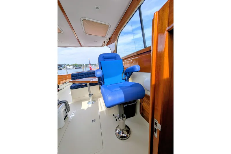Slide: The Image of Interior of 2003 Hinckley Picnic Boat 36 EP with blue captain's chair and wooden accents. - 23