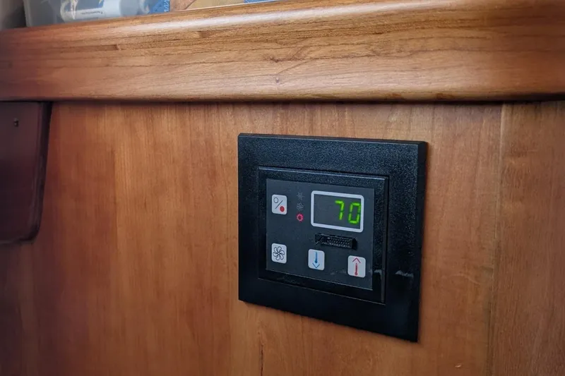 Slide: The Image of Thermostat control panel on 2003 Hinckley Picnic Boat 36 EP wooden interior. - 31