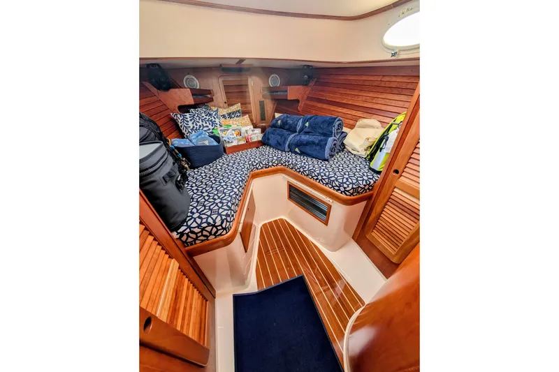 Slide: The Image of 2003 Hinckley Picnic Boat 36 EP cabin with cozy seating and nautical decor. - 35
