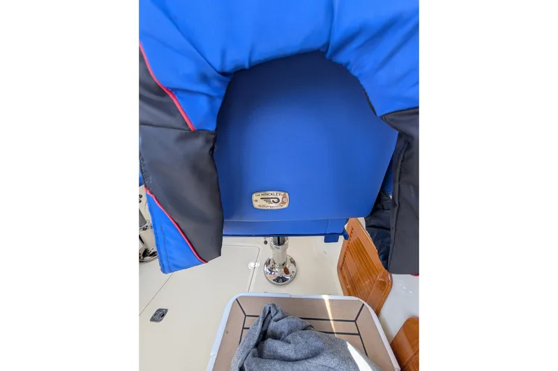 Slide: The Image of Blue seat on 2003 Hinckley Picnic Boat 36 EP, featuring a branded metal plaque. - 25