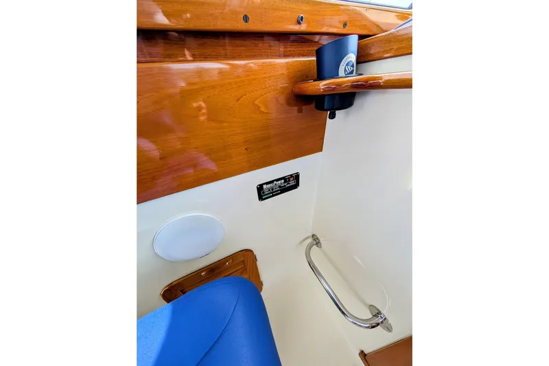 Slide: The Image of Interior detail of 2003 Hinckley Picnic Boat 36 EP, featuring wood paneling and seating. - 24