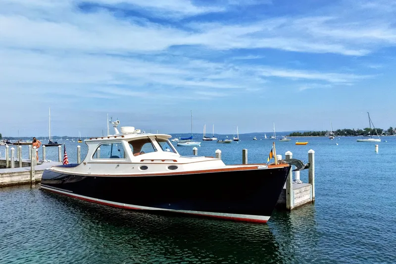 The Image of 2003 Hinckley Picnic Boat 36 EP docked in a scenic marina setting. - 0