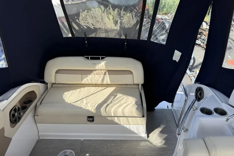 Slide: The Image of Interior of a 2019 Regal 28 Express boat with beige seating and cup holders. - 6
