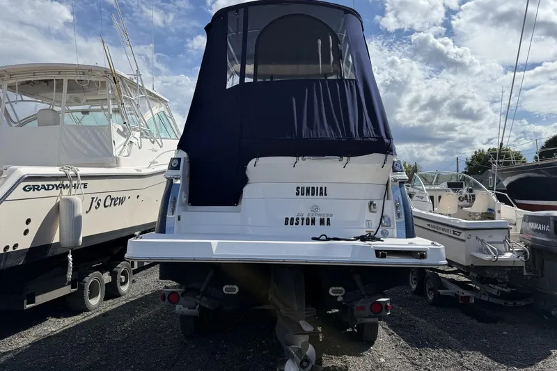 Slide: The Image of 2019 Regal 28 Express boat with blue cover, parked among other boats. - 5