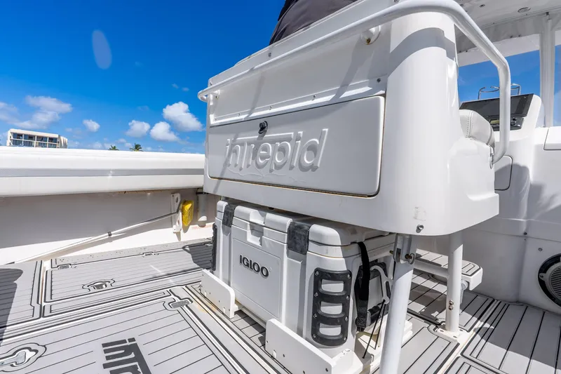 Slide: The Image of 2003 Intrepid 348 Walkaround boat deck with Igloo cooler under clear blue sky. - 20