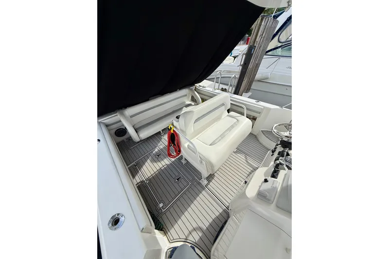 Slide: The Image of 2003 Intrepid 348 Walkaround boat interior with seating and steering area. - 3