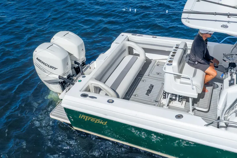 Slide: The Image of 2003 Intrepid 348 Walkaround boat with dual Mercury engines on blue water. - 15