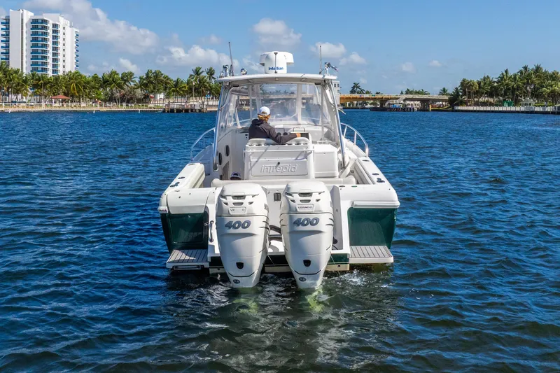 Slide: The Image of 2003 Intrepid 348 Walkaround boat with dual 400 engines on blue water. - 7