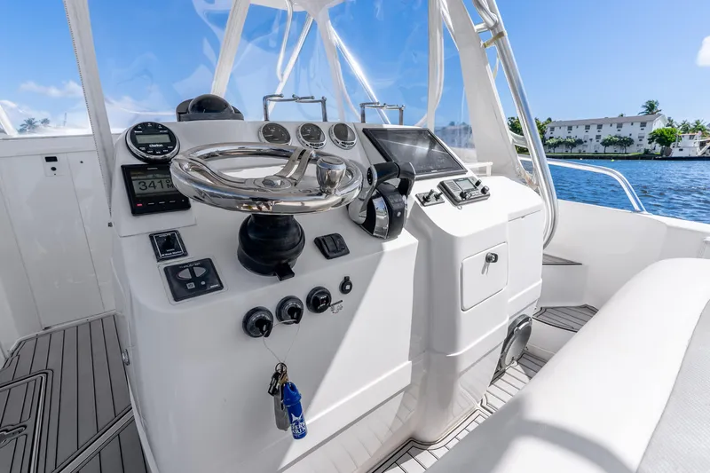 Slide: The Image of 2003 Intrepid 348 Walkaround boat helm with modern controls and ocean view. - 24