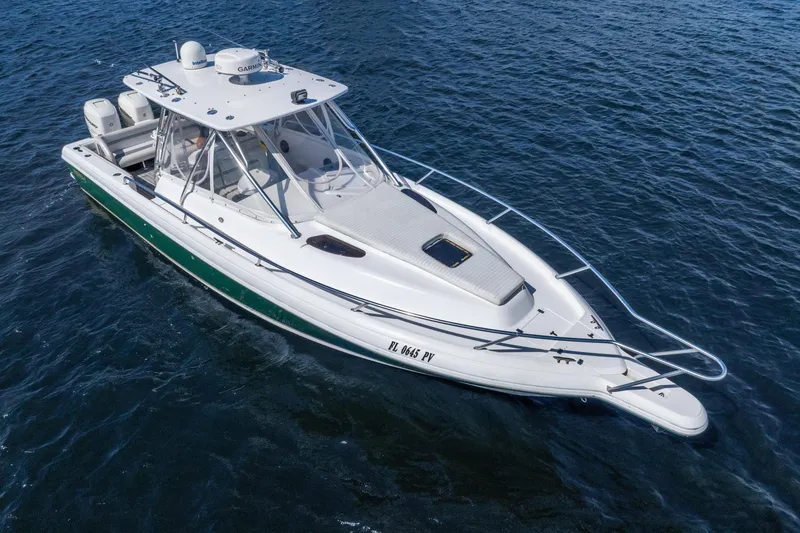 Slide: The Image of 2003 Intrepid 348 Walkaround boat on open water, featuring sleek design and modern equipment. - 13