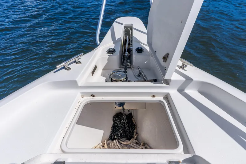 Slide: The Image of Bow storage compartment of a 2003 Intrepid 348 Walkaround boat with anchor and ropes. - 22