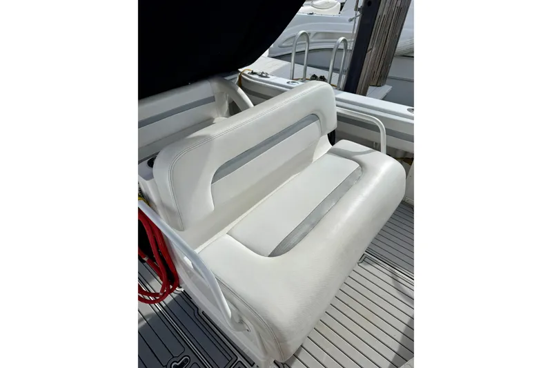 Slide: The Image of White seating on 2003 Intrepid 348 Walkaround boat, featuring sleek design and comfortable upholstery. - 4