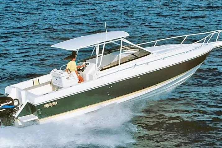 The Image of 2003 Intrepid 348 Walkaround boat cruising on open water. - 0