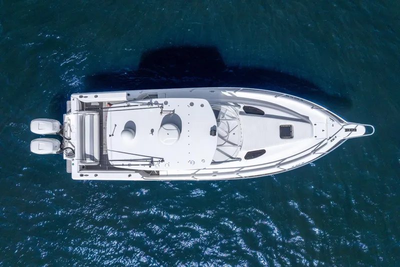 Slide: The Image of Overhead view of 2003 Intrepid 348 Walkaround boat on blue water. - 14