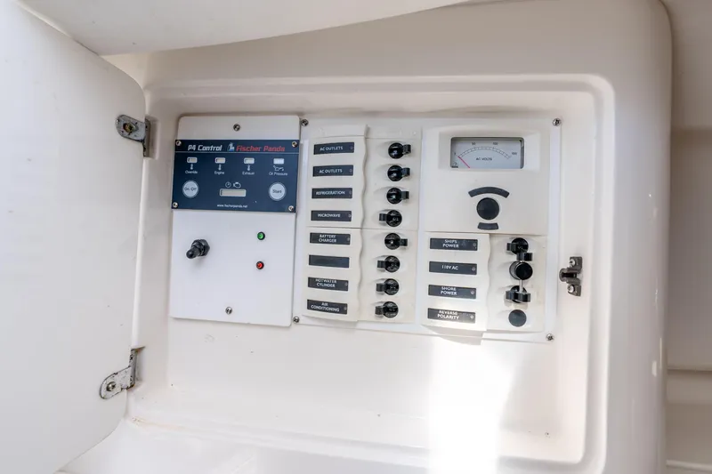 Slide: The Image of Electrical control panel on a 2003 Intrepid 348 Walkaround boat, featuring various switches and gauges. - 33