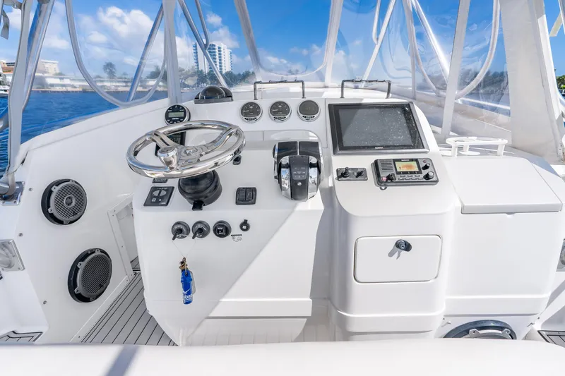 Slide: The Image of Helm of 2003 Intrepid 348 Walkaround boat with steering wheel and navigation controls. - 25