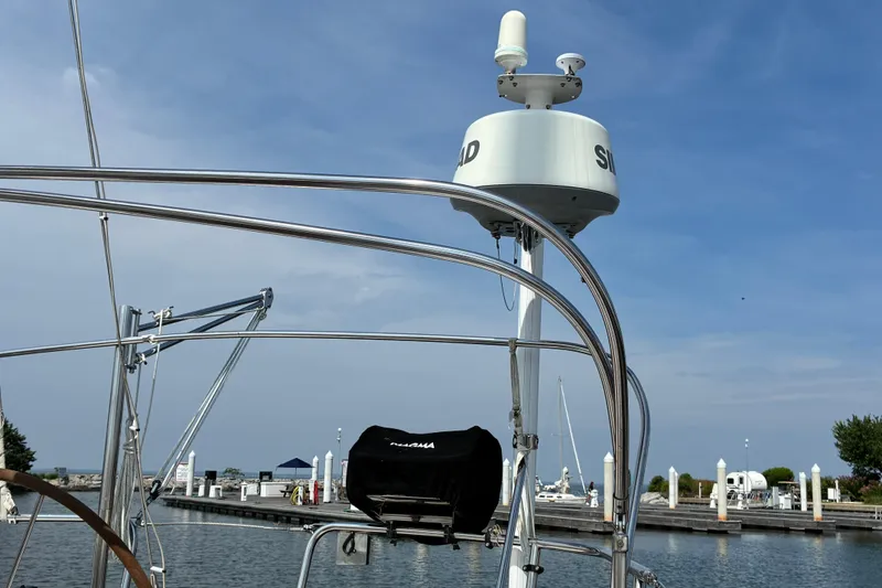 Slide: The Image of Sailboat with radar equipment at marina, featuring Sabre 452, 1999 model. - 9