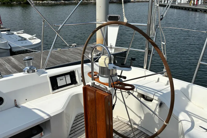 Slide: The Image of Cockpit of a 1999 Sabre 452 sailboat with wooden steering wheel and navigation equipment. - 5